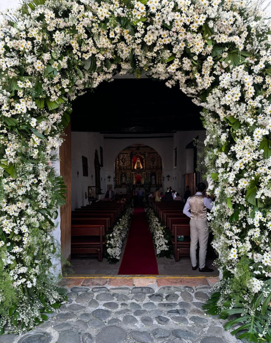 Arco de margaritas en la entrada de una iglesia para una boda